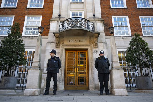 <p>Rasid Necati Aslim/Anadolu via Getty</p> Police officers stand guard outside The London Clinic on Jan. 18, after Kensington Palace announced Kate Middleton had had surgery there.