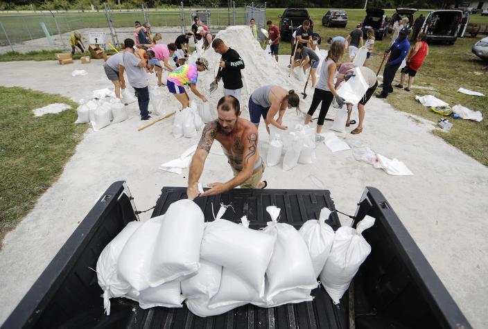 <p>Ryan Kaye loads sandbags into his truck at a makeshift filling station provided by the county as protection ahead of Hurricane Irma, Friday, Sept. 8, 2017, in Palm Coast, Fla. (Photo: David Goldman/AP) </p>