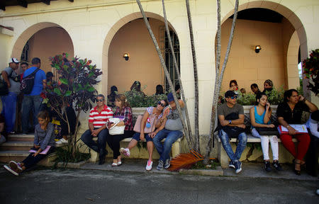 People wait for their turn inside Colombia's Embassy in Havana, Cuba, January 11, 2018. REUTERS/Alexandre Meneghini