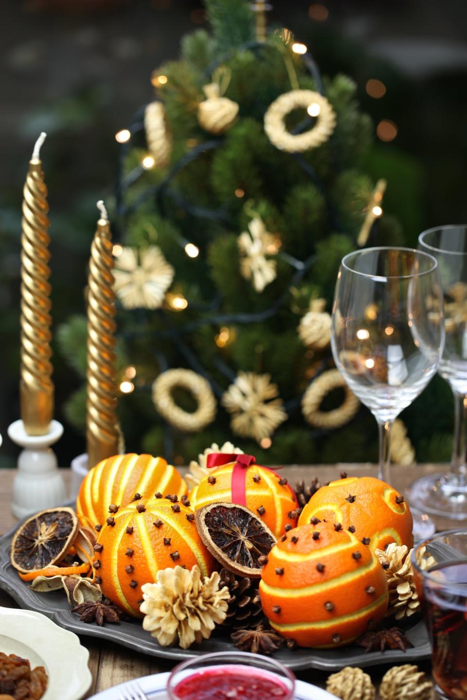 Clove-studded clementines for scent and face-height candles for lighting are essential (Getty/iStock)