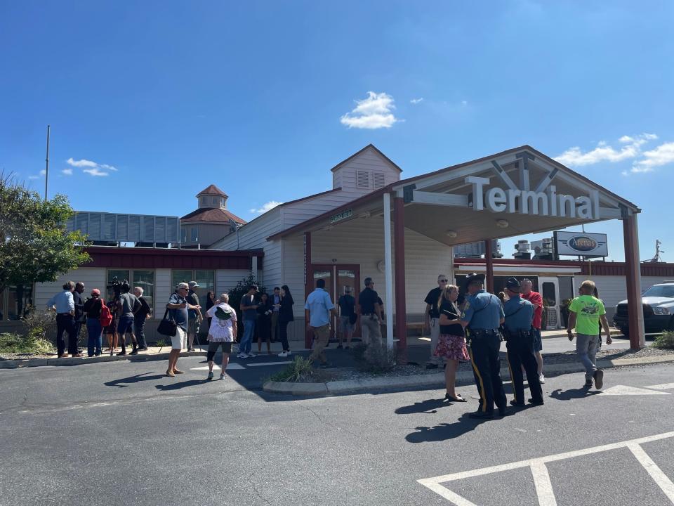 People wait outside Delaware Coastal Airport in Georgetown Tuesday, Sept. 20, 2022.