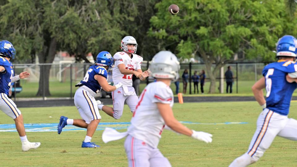 Seminole Ridge quarterback Dylan Reid rolls out to find a receiver during the first half of Friday’s preseason opener against Martin County (Aug. 18, 2023).