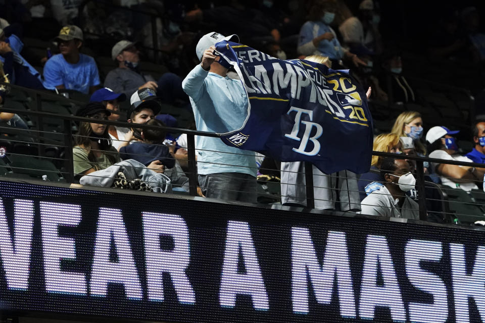 Tampa Bay Rays fans hold up a banner during the ninth inning in Game 5 of the baseball World Series against the Los Angeles Dodgers Sunday, Oct. 25, 2020, in Arlington, Texas. (AP Photo/Tony Gutierrez)