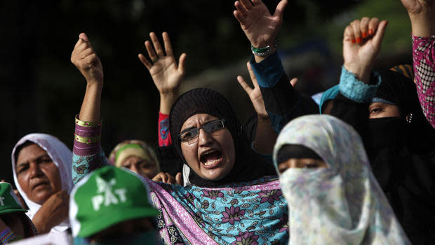 Supporters of Tahirul Qadri, Sufi cleric and leader of political party Pakistan Awami Tehreek (PAT), gesture as they chant slogans during the Revolution March in Islamabad Aug. 18, 2014.