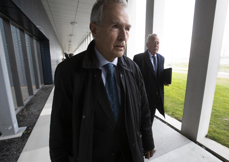 Anton Kotte, left, who lost his son, daughter-in-law and grandson, and Piet Ploeg, right, who lost his brother, Alex, his sister-in-law and his nephew, arrive at the court for the trial of four men charged with murder over the downing of Malaysia Airlines flight 17, at Schiphol airport, near Amsterdam, Netherlands, Monday, March 9, 2020. A missile fired from territory controlled by pro-Russian rebels in Ukraine in 2014, tore the MH17 passenger jet apart killing all 298 people on board. (AP Photo/Peter Dejong)