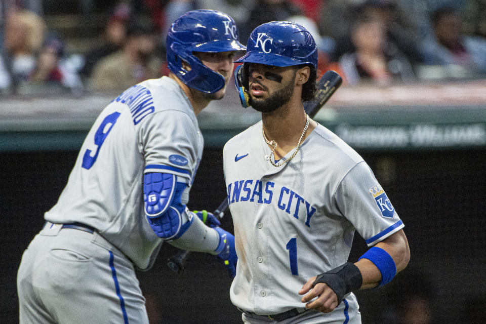 Kansas City Royals' MJ Melendez scores on a RBI single by Salvador Perez and is greeted at home plate by Vinnie Pasquantino during the third inning of a baseball game in Cleveland, Saturday, Oct. 1, 2022. (AP Photo/Phil Long)