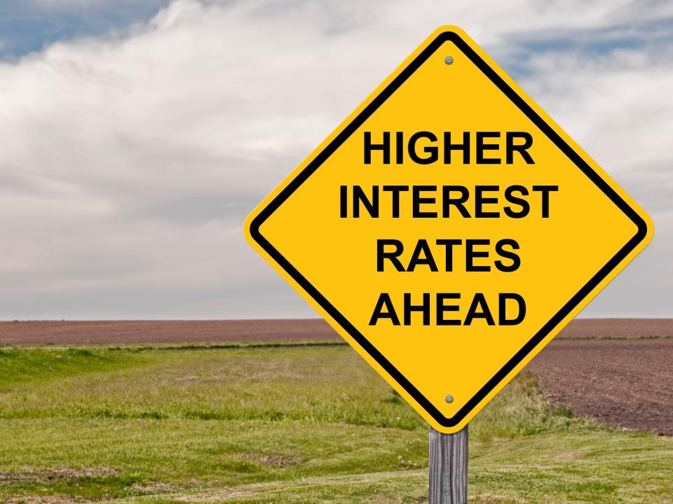 I road sign that reads higher interest rates ahead.