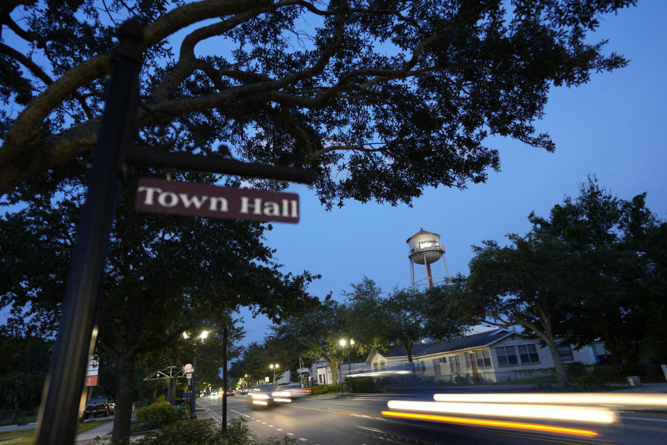 Cars drive down East Kennedy Boulevard through the heart of Eatonville, Fla., which incorporated in 1887 as one of the country's first self-governing Black municipalities, Wednesday, Aug. 23, 2023. (AP Photo/Rebecca Blackwell)