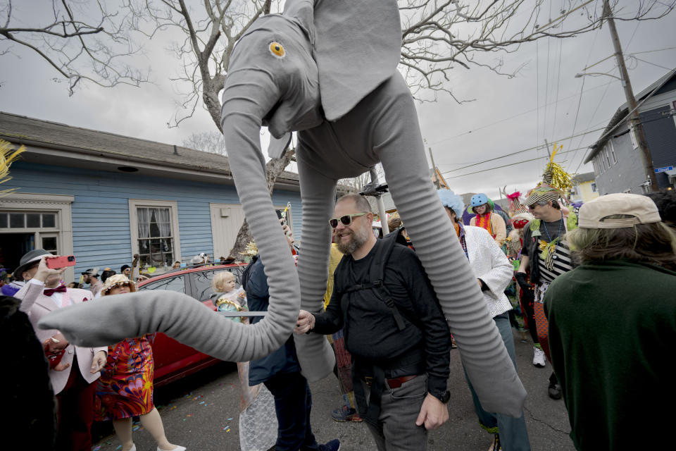 People walk in costumes during the Society of Saint Anne parade through Bywater and Marigny neighborhoods on Mardi Gras Day in New Orleans, Tuesday, Feb. 13, 2024. (AP Photo/Matthew Hinton)