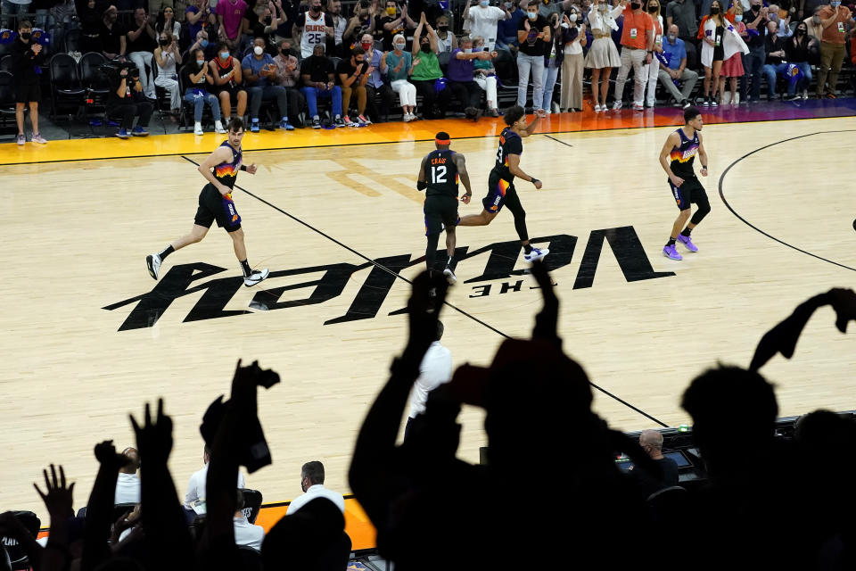 From left; Phoenix Suns forward Dario Saric, forward Torrey Craig, forward Cameron Johnson and guard Devin Booker celebrate after a basket against the Denver Nuggets during the second half of Game 2 of an NBA basketball second-round playoff series, Wednesday, June 9, 2021, in Phoenix. (AP Photo/Matt York)