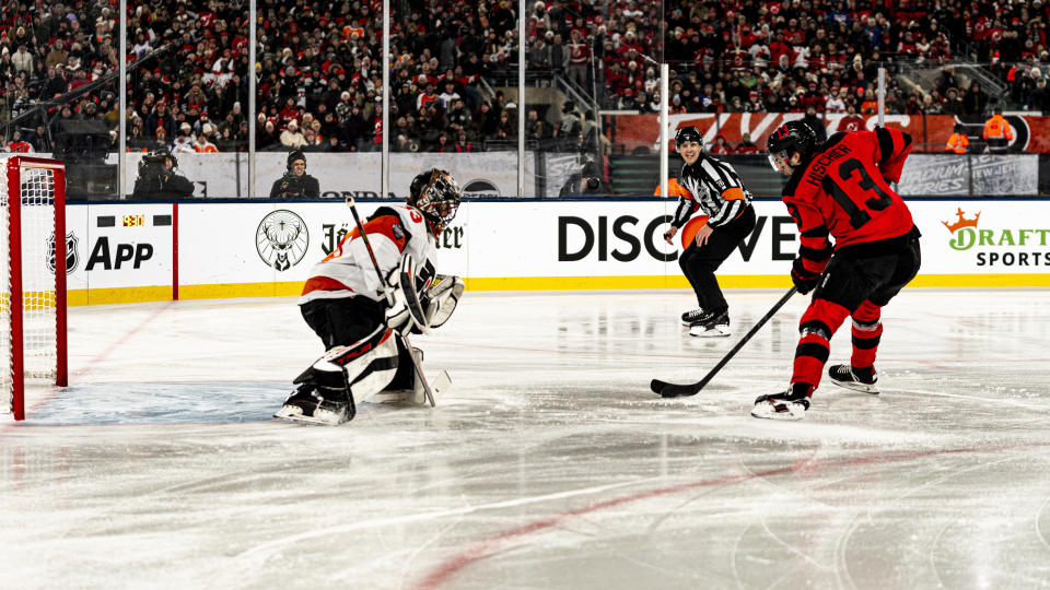 New Jersey Devils center Nico Hischier (13) shoots against Philadelphia Flyers goaltender Samuel Ersson, left, in the first period of an NHL Stadium Series hockey game in East Rutherford, N.J., Saturday, Feb. 17, 2024. (AP Photo/Peter K. Afriyie)