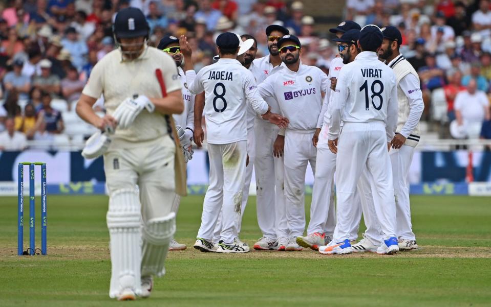 India's players celebrate as England's Jonny Bairstow walks back to the pavilion after losing his wicket for 29 during play on the first day of the first cricket Test match of the India Tour of England 2021 between England and India at the Trent Bridge cricket ground in Nottingham, central England on August 4, 2021. - AFP