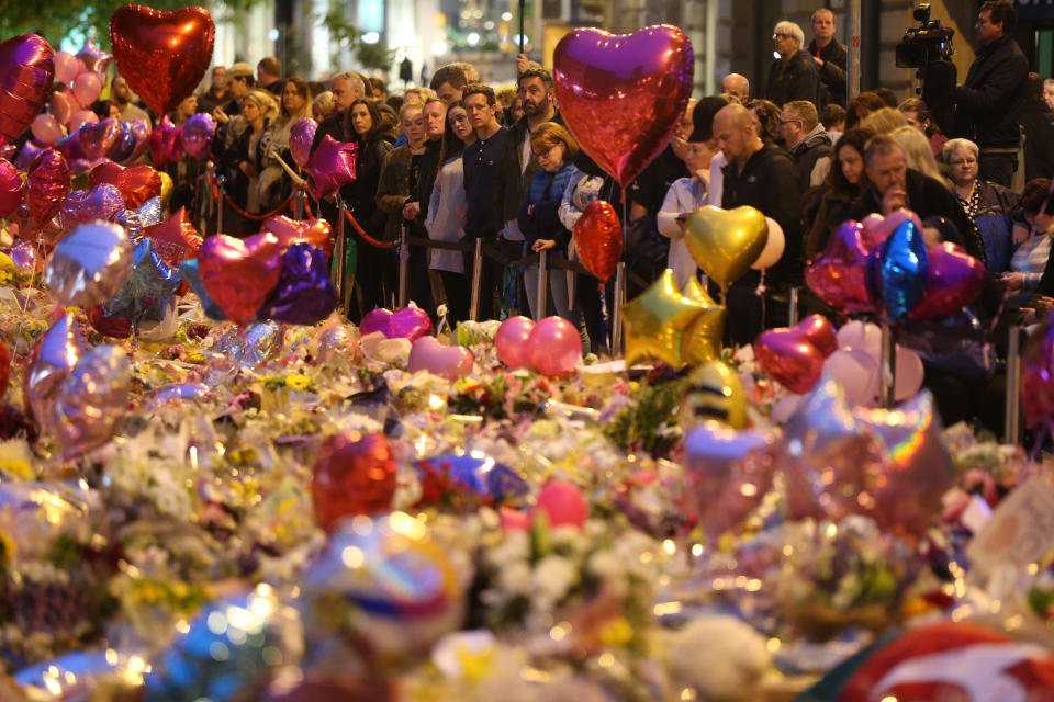 Mourners view tributes in St Ann's Square, Manchester, as they prepare to mark the passing of exactly a week since the Manchester Arena terror attack.