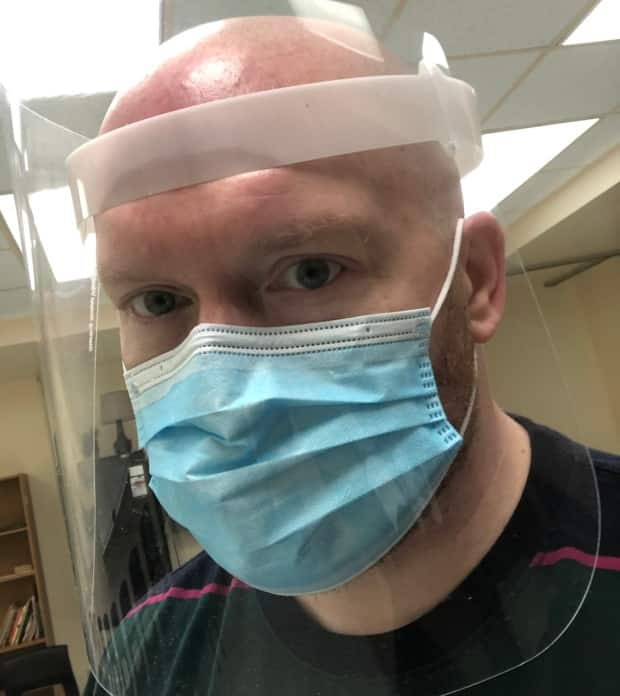 Jordan Stringer, a teacher at Corner Brook Regional High School, wears eye protection and a disposable three-ply mask, which are now mandatory for staff. 