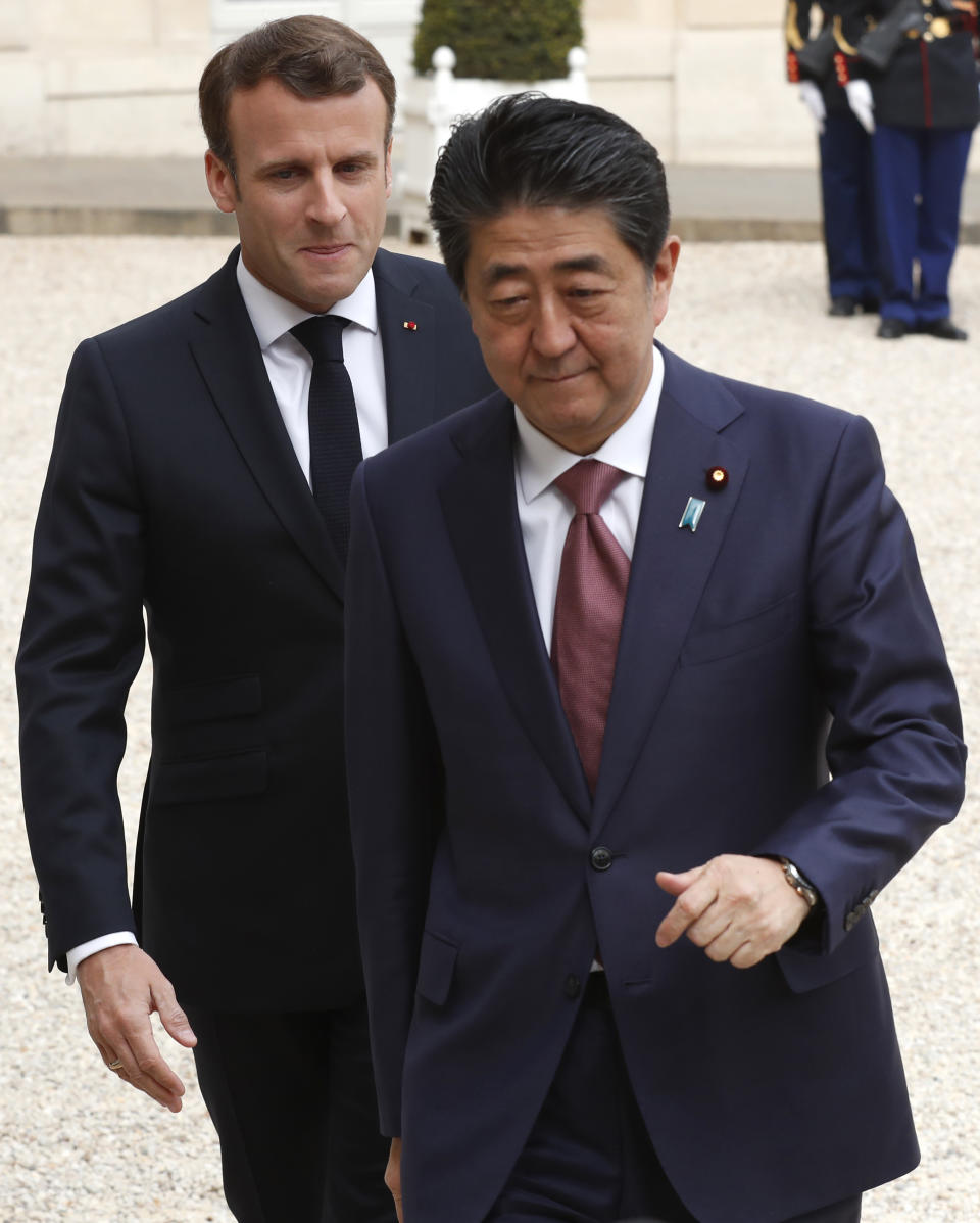 French President Emmanuel Macron, left, welcomes Japan's Prime Minister Shinzo Abe before their talks at the Elysee Palace, Tuesday, April 23, 2019 in Paris. (AP Photo/Thibault Camus)