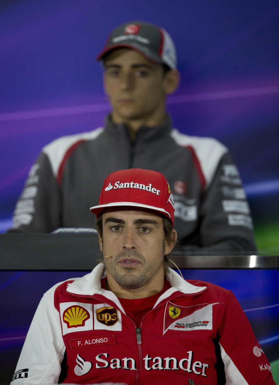 Ferrari driver Fernando Alonso of Spain, speaks in front of Sauber driver Esteban Gutierrez of Mexico during the press conference ahead of Sunday's Chinese Formula One Grand Prix at Shanghai International Circuit in Shanghai, China Thursday, April 17, 2014. (AP Photo/Andy Wong)