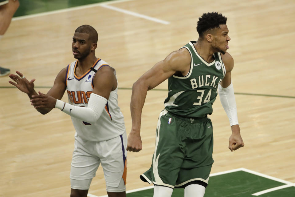 Milwaukee Bucks' Giannis Antetokounmpo (34) reacts after a dunk during the second half of Game 3 of basketball's NBA Finals against the Phoenix Suns, Sunday, July 11, 2021, in Milwaukee. (AP Photo/Aaron Gash)