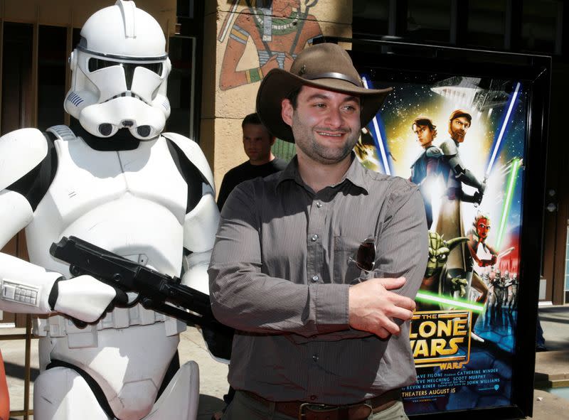 FILE PHOTO: Dave Filoni, director of the new animated film "Star Wars: The Clone Wars", poses with a Storm Trooper character at the film's U.S. premiere in Hollywood