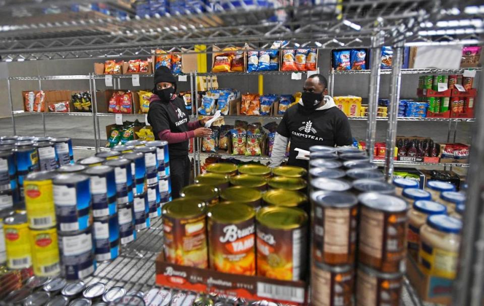 E-grocer Farmstead is expanding its services in Charlotte since opening in mid-November. Workers Shinesia Whatley, left, and Matthew Brown tag grocery items in this file photo.