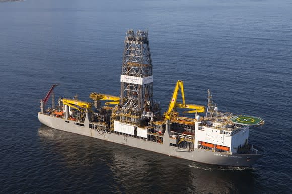 Drilling rig ship at sea with Transocean logo.