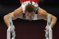 Sam Mikulak competes on the parallel bars during the men's U.S. Olympic Gymnastics Trials Thursday, June 24, 2021, in St. Louis. (AP Photo/Jeff Roberson)