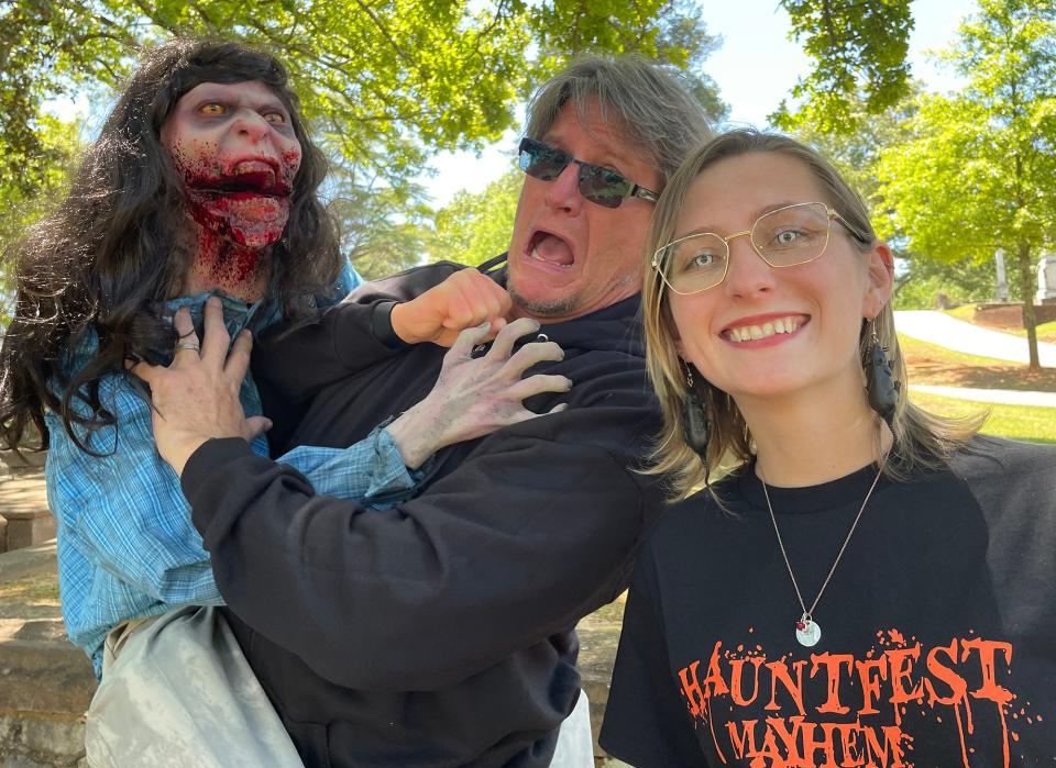 From left: "Molly," Scott Harpold and Roseann Harpold pose for a candid shot at Oconee Hill Cemetery in Athens on May 4. The Harpolds are the purveyors of Harpold Manor, a haunted attraction in Elbert County, and are staging Hauntfest Mayhem on Saturday at Rabbit Hole Studios.