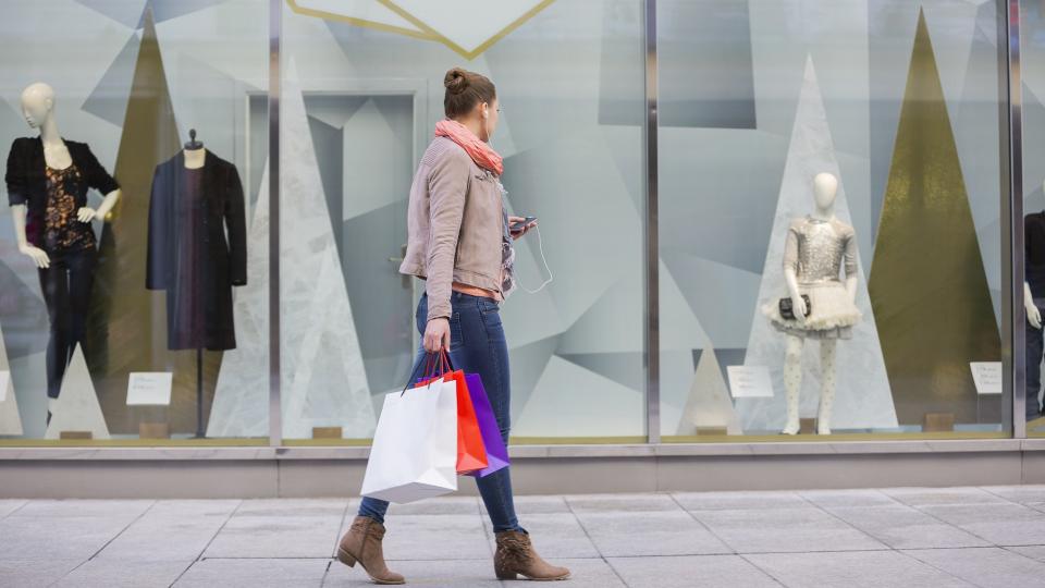 woman window shopping for luxury clothes