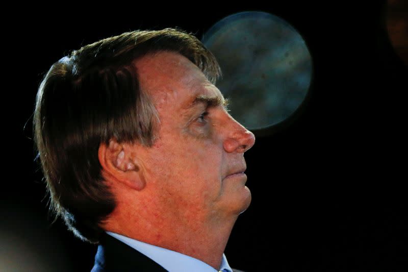 Brazil's President Jair Bolsonaro looks on while meeting supporters and Catholic faithfuls as he arrives at Alvorada Palace, amid the coronavirus disease (COVID-19) outbreak, in Brasilia