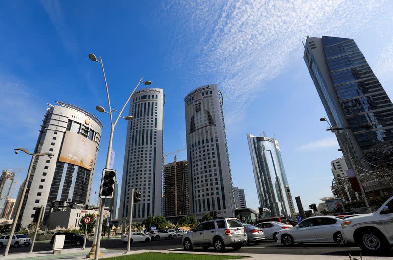 FILE PHOTO: Vehicles are seen in a traffic jam in front of government buildings next to skyscrapers in Doha