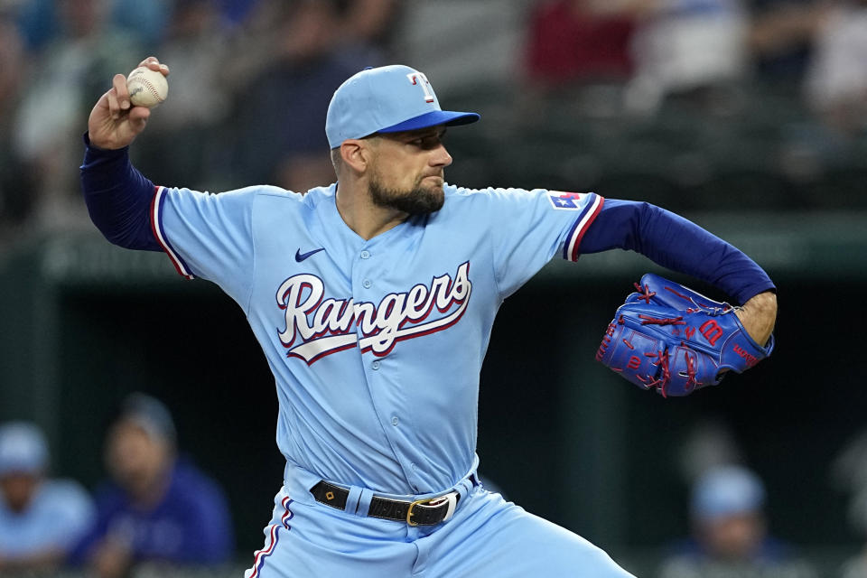 Texas Rangers starting pitcher Nathan Eovaldi throws to the Seattle Mariners in the first inning of a baseball game, Sunday, June 4, 2023, in Arlington, Texas. (AP Photo/Tony Gutierrez)