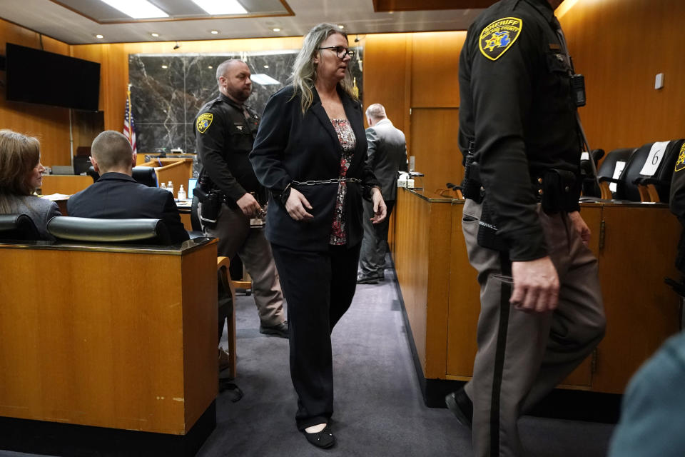 Jennifer Crumbley is escorted out of the Oakland County courtroom, Friday, Feb. 2, 2024, in Pontiac, Mich. Crumbley, 45, is charged with involuntary manslaughter. Prosecutors say she and her husband were grossly negligent and could have prevented the four deaths if they had tended to their son’s mental health. They’re also accused of making a gun accessible at home. (AP Photo/Carlos Osorio, Pool)