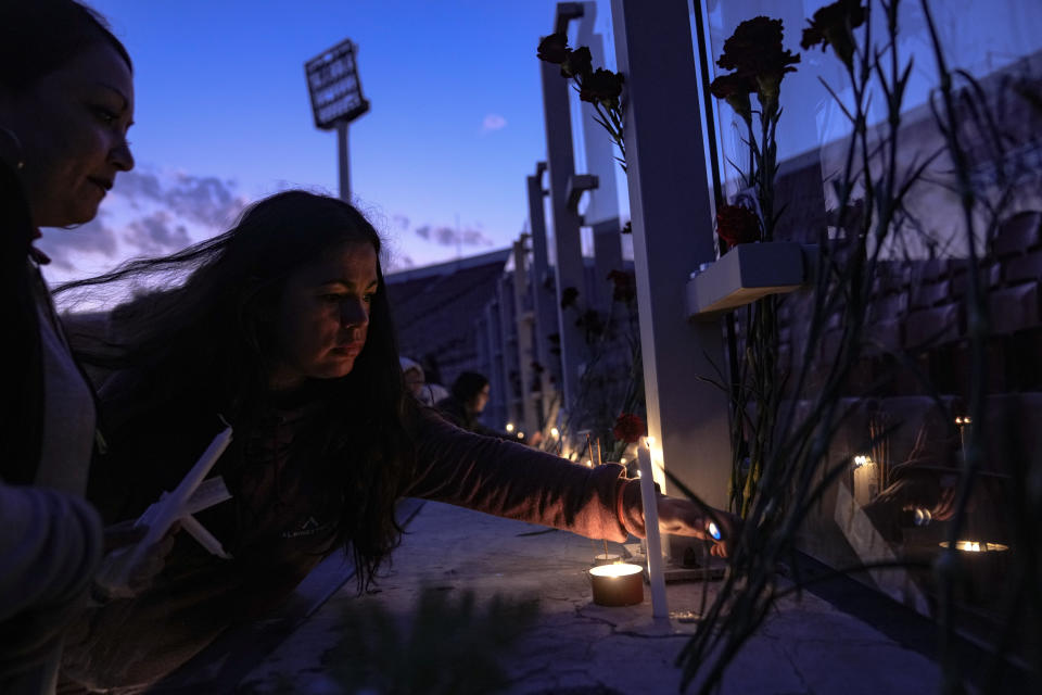 FILE - Women light candles at the National Stadium, which served as a detention and torture center in the early days of the military dictatorship, during a vigil marking the 50th anniversary of the 1973 military coup that toppled the government of late President Salvador Allende, in Santiago, Chile, Monday, Sept. 11, 2023. Chile's Truth Commission, which looked into crimes of the dictatorship, said some pregnant women lost their babies at the National Stadium because of the torture and sexual abuse. (AP Photo/Esteban Felix, File)
