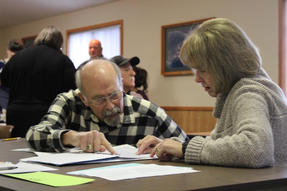 Local officials assist in the recount of the Proposal 3 ballots at the Charlevoix Township Hall on Dec. 12.