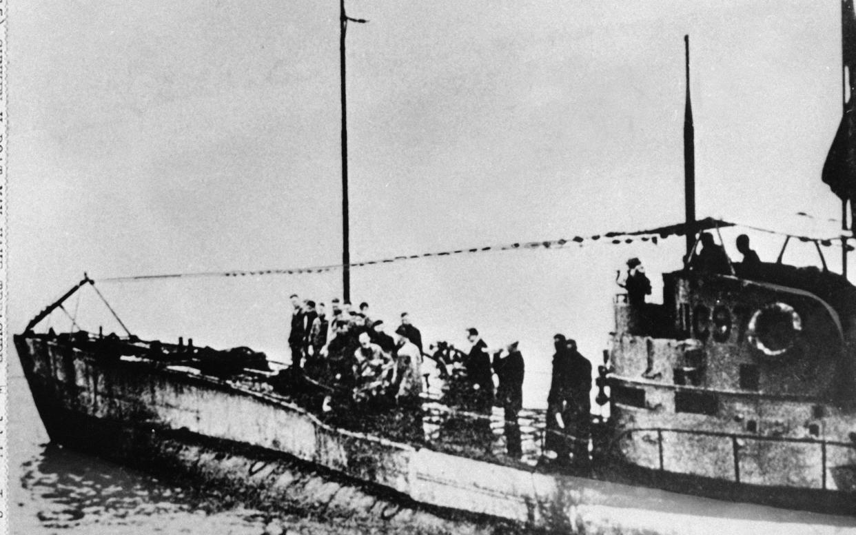 In this undated photo people stand on the deck of a World War I German submarine type UC-97 in an unknown location. - AP