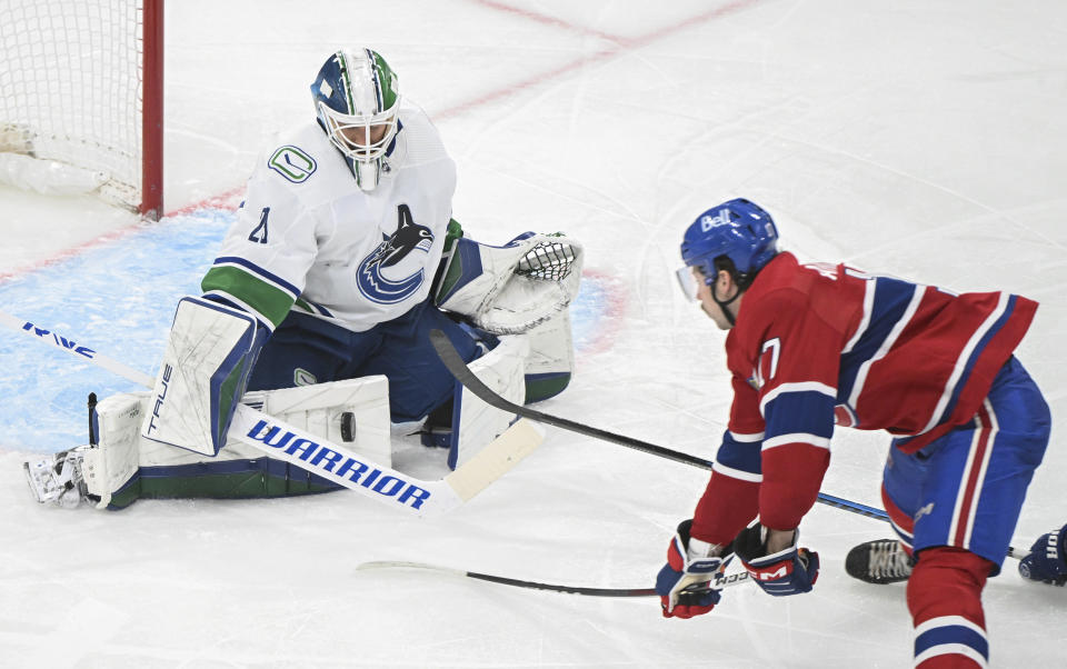 Vancouver Canucks goaltender Casey DeSmith, left, stops Montreal Canadiens' Josh Anderson, right, during third-period NHL hockey game action in Montreal, Sunday, Nov. 12, 2023. (Graham Hughes/The Canadian Press via AP)