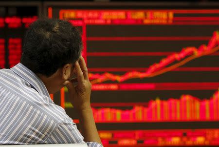 An investor watches an electronic board showing stock information at a brokerage office in Beijing, China, July 9, 2015. REUTERS/Kim Kyung-Hoon