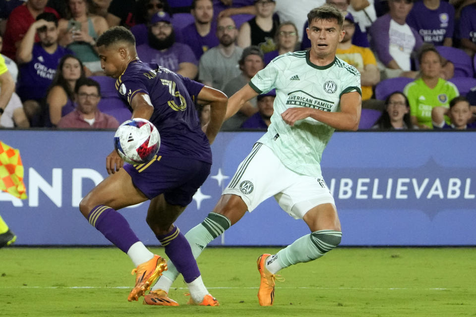 Atlanta United forward Miguel Berry, right, watches his shot on goal that gets past Orlando City defender Rafael Santos (3) during the second half of an MLS soccer match, Saturday, May 27, 2023, in Orlando, Fla. (AP Photo/John Raoux)