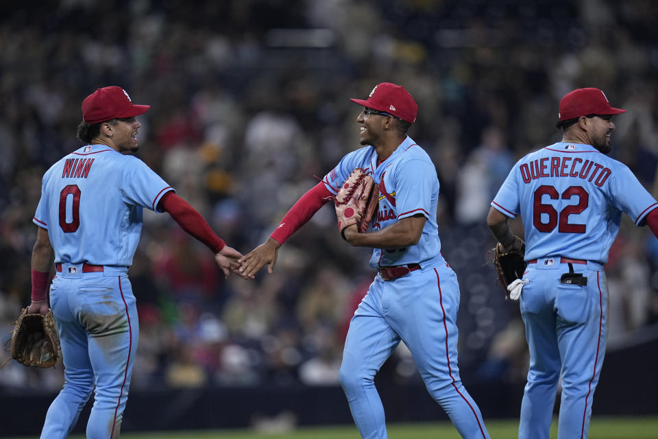 St. Louis Cardinals shortstop Masyn Winn (0) celebrates with teammates left fielder Richie Palacios, center, and third baseman Juniel Querecuto (62) after the Cardinals defeated the San Diego Padres 5-2 in a baseball game Saturday, Sept. 23, 2023, in San Diego. (AP Photo/Gregory Bull)