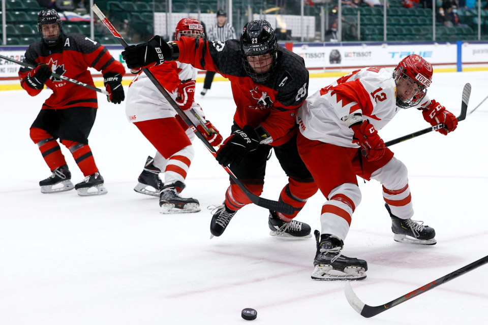 Canada's Mason McTavish (23) battles Russia's Dmitri Katelevski (12) in the U-18 world championship title game May 6, 2021.