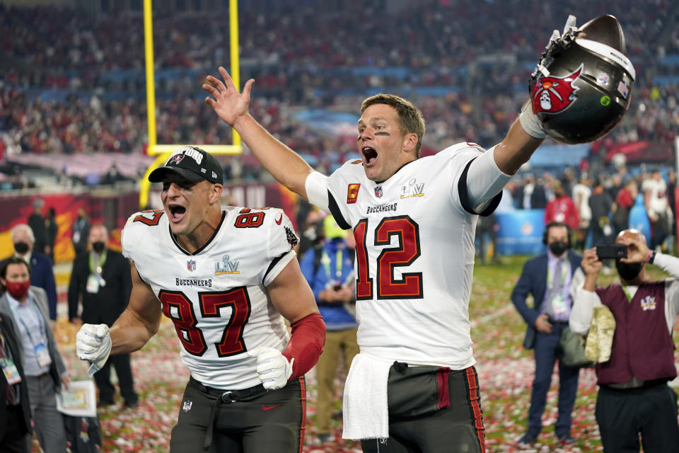 CORRECTS TO SEVENTH SUPER BOWL TITLE FOR BRADY, INSTEAD OF FIFTH - FILE - Tampa Bay Buccaneers tight end Rob Gronkowski, left, and quarterback Tom Brady (12) celebrate after the NFL Super Bowl 55 football game against the Kansas City Chiefs in Tampa, Fla., Feb. 7, 2021. Brady's seventh Super Bowl title, at 43 no less, was one of the best moments of 2021, when a continuing pandemic could not dim the brightest of stars of the sports world. (AP Photo/Steve Luciano, File)