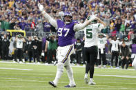 Minnesota Vikings defensive tackle Harrison Phillips (97) reacts in front of New York Jets quarterback Mike White (5) after a defensive stop during the second half of an NFL football game, Sunday, Dec. 4, 2022, in Minneapolis. (AP Photo/Bruce Kluckhohn)