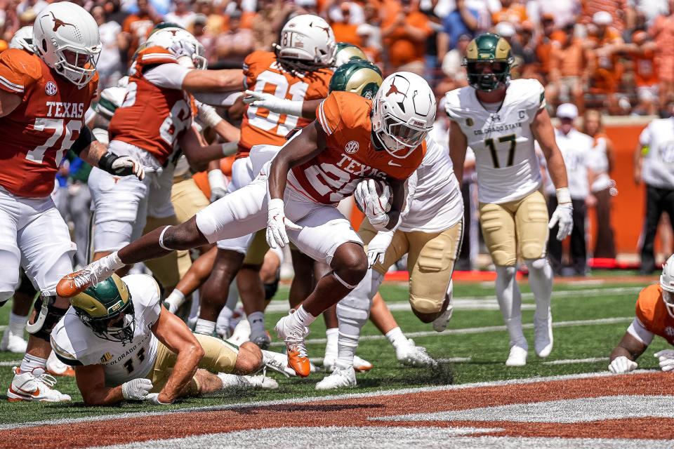 Texas running back Quintrevion Wisner (26) dives into the end zone for a touchdown against Colorado State at Darrell K Royal-Texas Memorial Stadium.