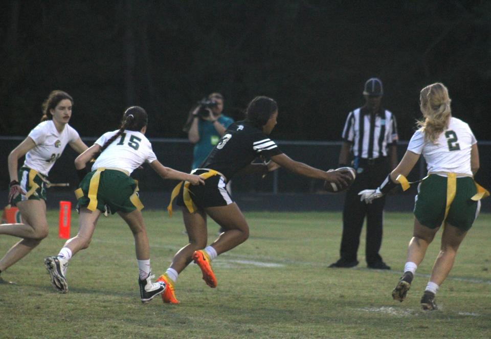 Davie Western wide receiver Veronica McBride (3) lunges for the end zone as Fleming Island defenders try for a flag pull during the Florida High School Athletic Association Class 2A flag football semifinal on May 13, 2022. [Clayton Freeman/Florida Times-Union]