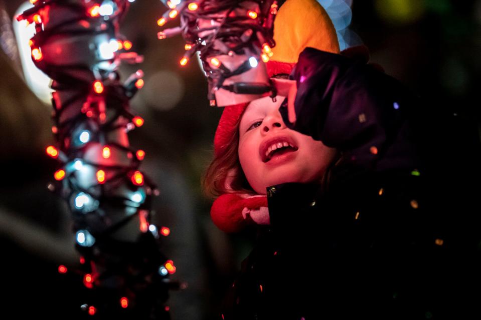 Adele Lowe, 5, scopes out the International Festival of Lights before the Battle Creek Christmas Parade on Saturday, Nov. 20, 2021.