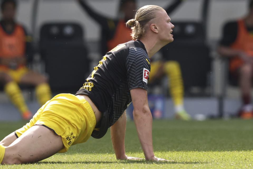 Dortmund's Erling Haaland lies on a German Bundesliga soccer match between Greuther Fuerth and Borussia Dortmund in Fuerth, Germany, Saturday, May 7, 2022. (Daniel Karmann/dpa via AP)