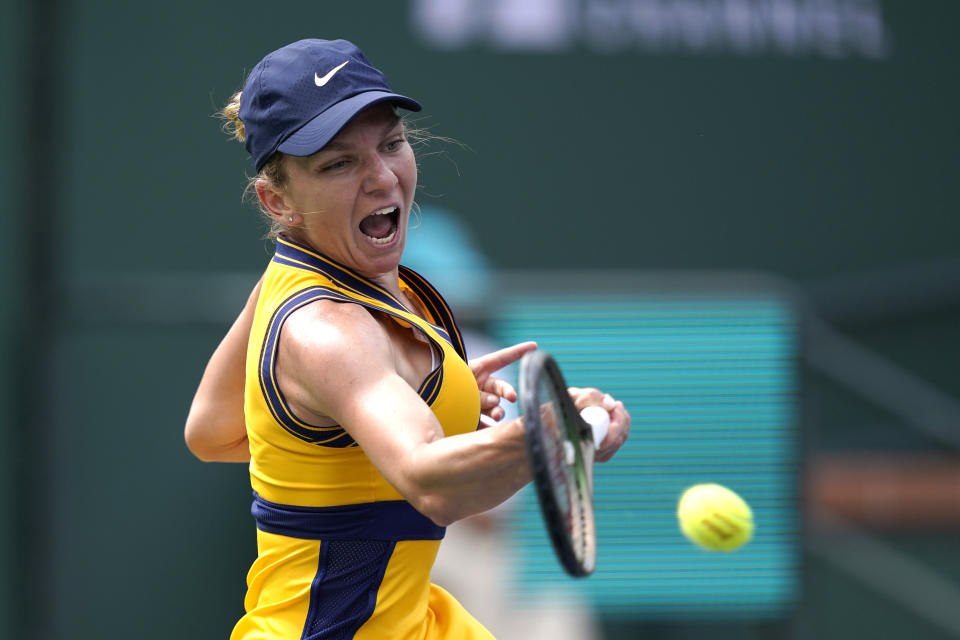 Simona Halep, of Romania, returns to Marta Kostyuk, of Ukraine, at the BNP Paribas Open tennis tournament Friday, Oct. 8, 2021, in Indian Wells, Calif. (AP Photo/Mark J. Terrill)