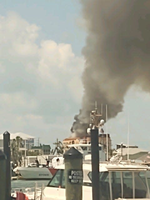 Smoke billows from a building at the north end of Fort Myers Beach