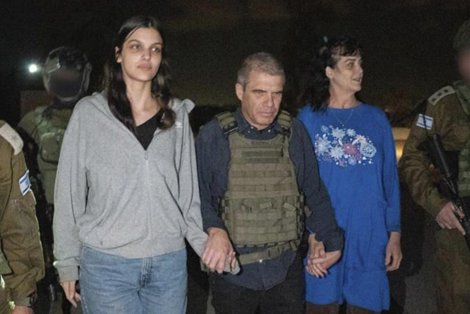 In this photo provided by the Government of Israel, Judith Raanan, right, and her 17-year-old daughter Natalie are escorted by Israeli soldiers and Gal Hirsch, Prime Minister Benjamin Netanyahu's special coordinator for returning the hostages, as they return to Israel from captivity in the Gaza Strip, Friday, Oct. 20, 2023. Hamas released the pair in what it said was a goodwill gesture late Friday, nearly two weeks after they were captured in a bloody cross-border raid by the Islamic militant group. The Hamas attack sparked a war that is entering its third week, and Hamas is believed to still be holding some 200 people hostage. (Government of Israel via AP Photo)