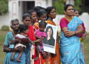 Indian village women, one holding a placard featuring U.S. Vice President-elect Kamala Harris during celebrations for her victory, in Painganadu a neighboring village of Thulasendrapuram, the hometown of Harris' maternal grandfather, south of Chennai, Tamil Nadu state, India, Sunday, Nov. 8, 2020. Waking up to the news of Kamala Harris' election as Joe Biden's running mate, overjoyed people in her Indian grandfather's hometown are setting off firecrackers, carrying her placards and offering prayers. (AP Photo/Aijaz Rahi)