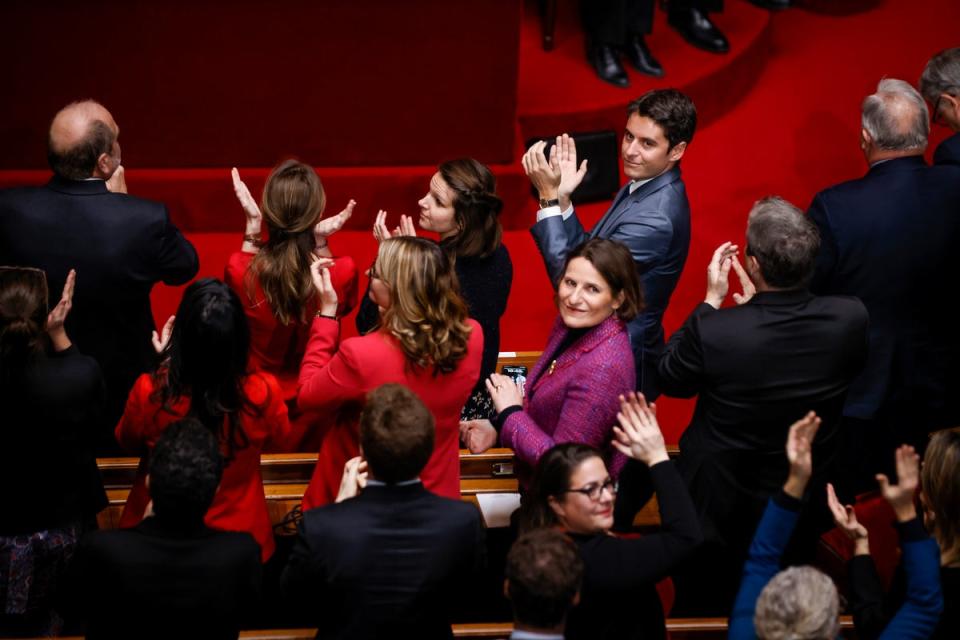 French Prime Minister Gabriel Attal, right, applauds after lawmakers approved the abortion as a constitutional right, at the Palace of Versailles (Thomas Padilla / AP)